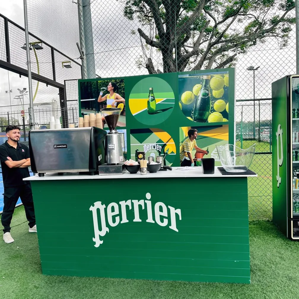 The Perrier coffee-and-drinks station with court graphics behind